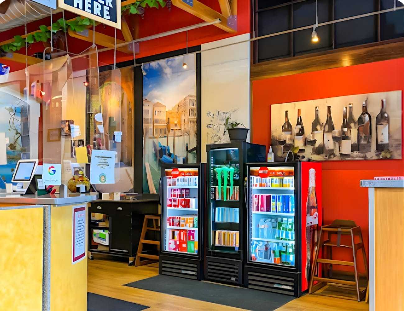 Modern store interior with colorful fridges, wine decor, and bright wooden accents.